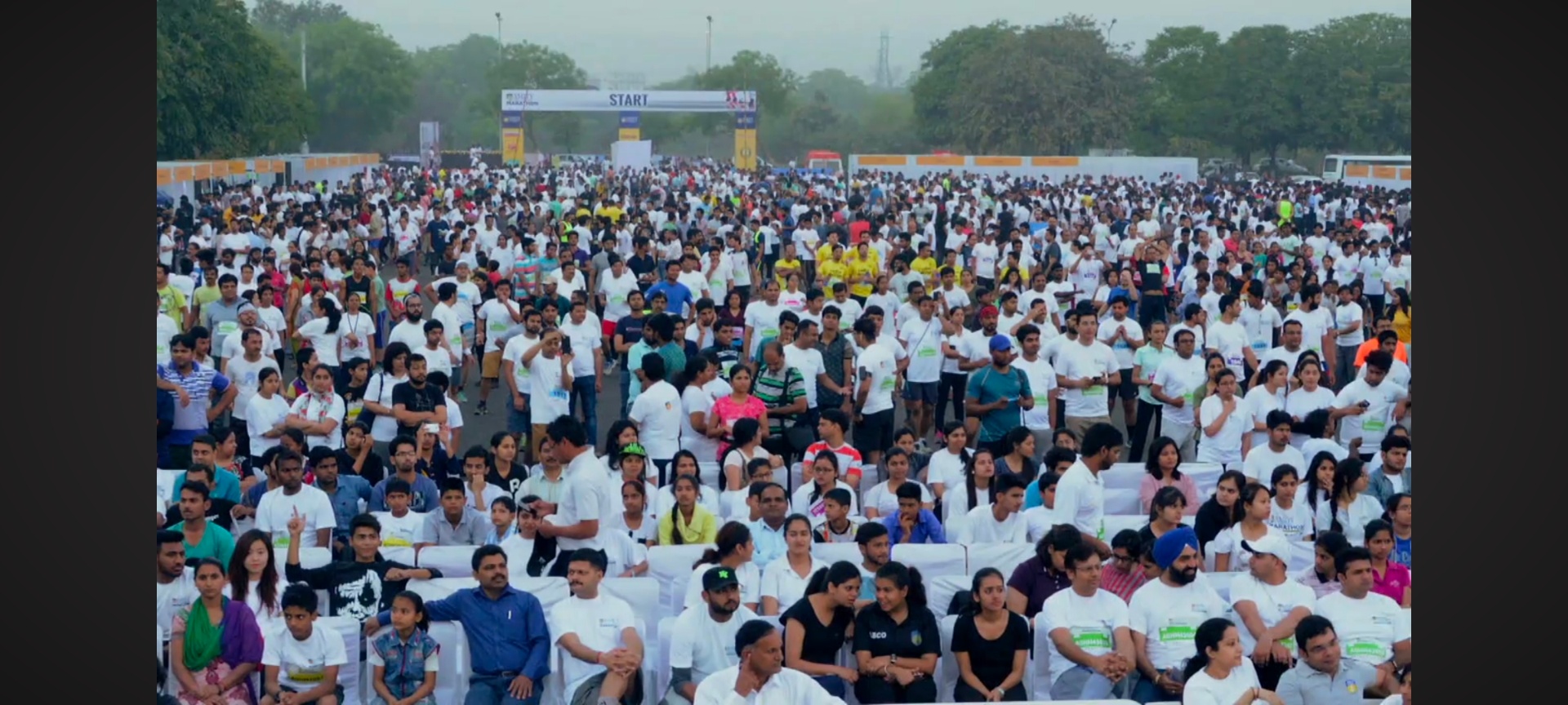 Amity Gurgaon Half Marathon — Thousands at the start line — leading the mass warm-up