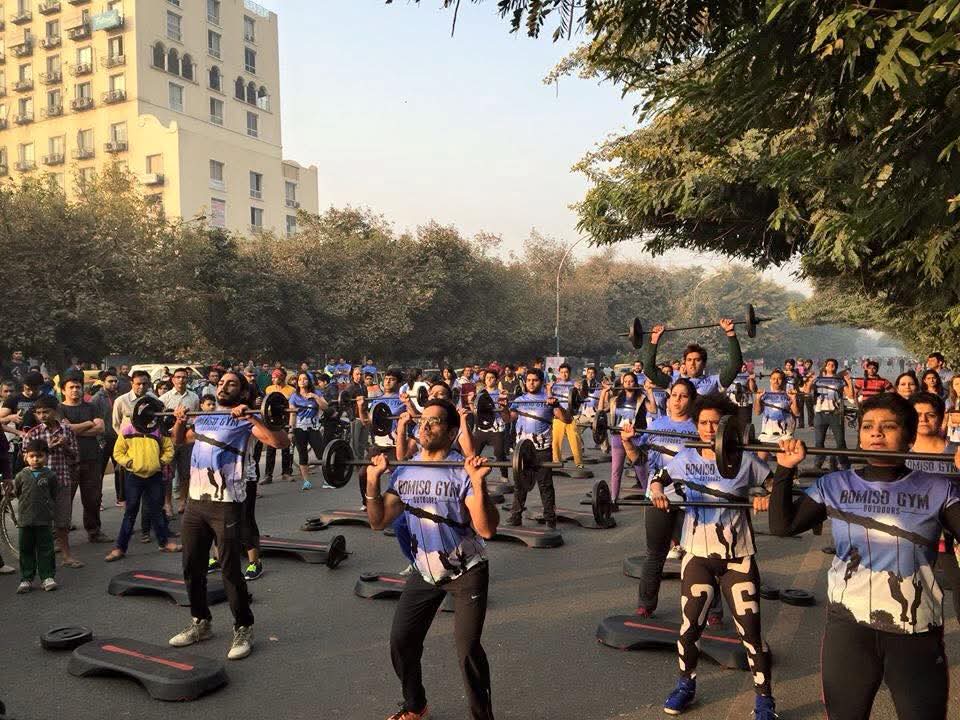 Raahgiri Day · Street Strength — Hundreds of participants training with barbells on a car-free Gurgaon street.